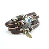 FASHIONA - Heren brede armband. Boho en hippie stijl met evil eye, uil en veer. Geïnspireerd op de jaren '60 en '70. Gemaakt van kralen, metaal, touw en leer. 2