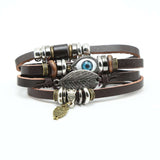FASHIONA-Heren brede armband. Boho en hippie stijl met evil eye, uil en veer. Geïnspireerd op de jaren '60 en '70. Gemaakt van kralen, metaal, touw en leer.